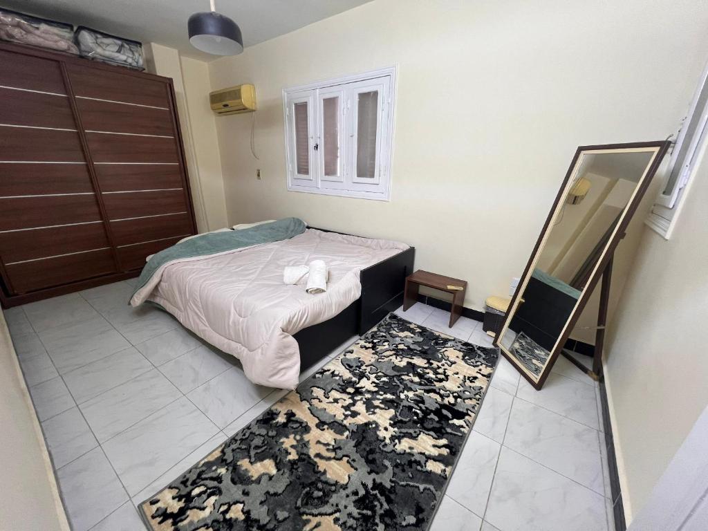 um quarto com uma cama e um espelho em 2Brs Downtown Heliopolis l Near services no Cairo