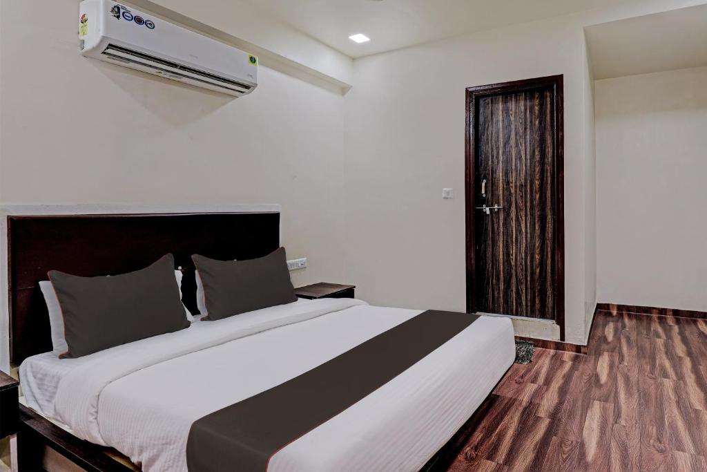 a bedroom with a large bed in a room at Collection O Hotel Royal Inn in Ahmedabad