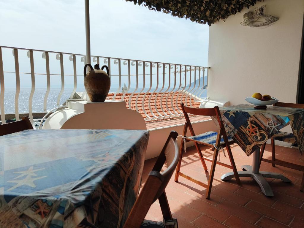 a room with a table and a view of the ocean at B&B Ventura in Lipari