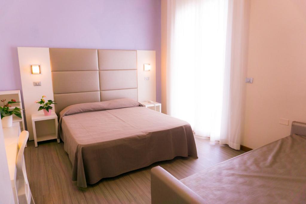Postel nebo postele na pokoji v ubytování New Hotel Chiari