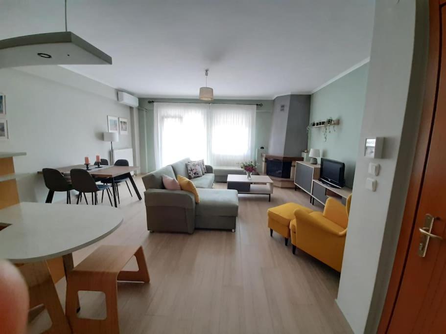 a living room with a couch and a table at Spacious and comfy apartment in Nea Moudania