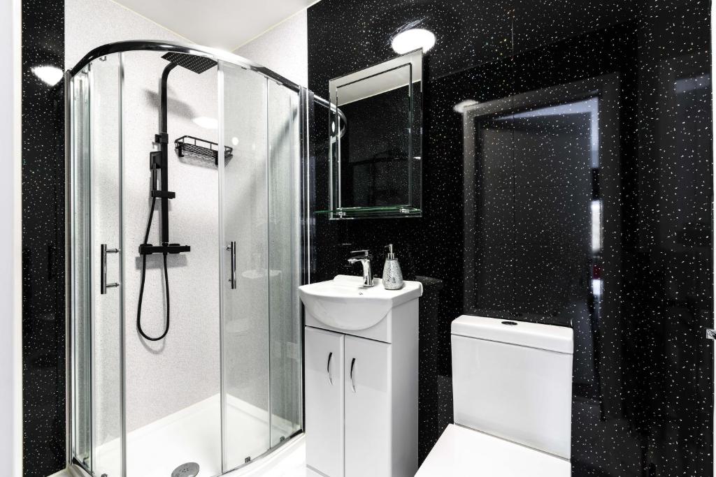 Copthorne的住宿－Lovely Modern Room，黑白浴室设有淋浴和水槽