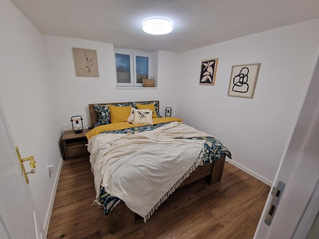 a bedroom with a bed with yellow pillows on it at Apartman Pobednik in Belgrade