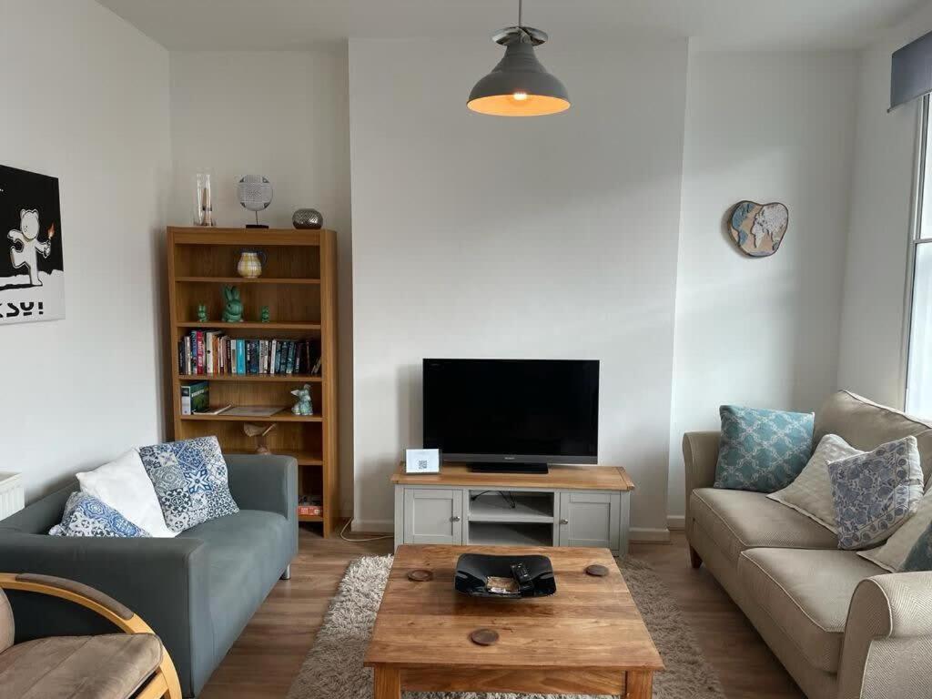 a living room with a couch and a tv at Wonderful 3 Bed in Old Market in Bristol