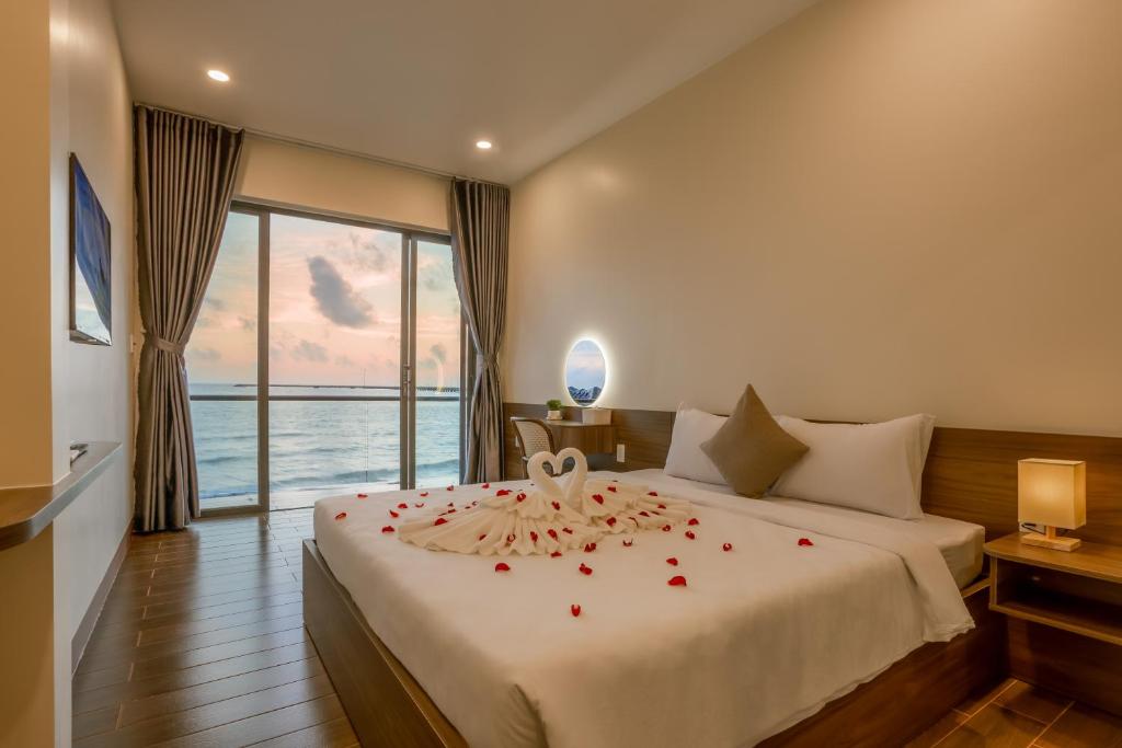 a hotel room with a bed with roses on it at Wave Sound Beach House Phu Quoc in Phu Quoc