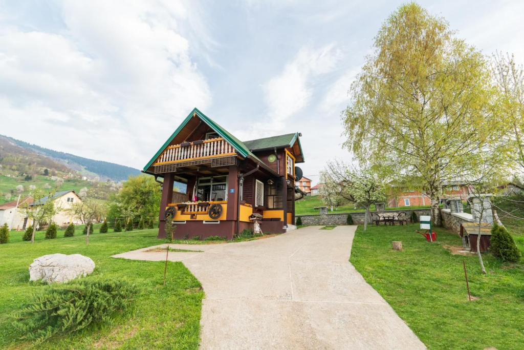a small house in a field with a walkway at Salerno camp in Plav