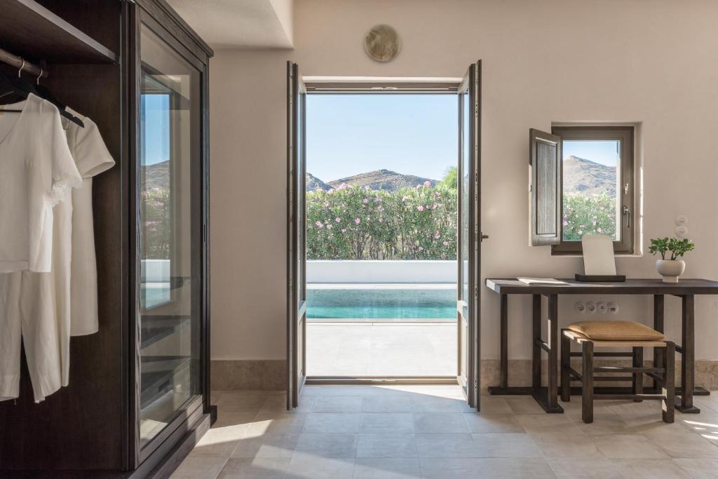 a dressing room with a desk and a window at Parilio, a Member of Design Hotels in Naousa