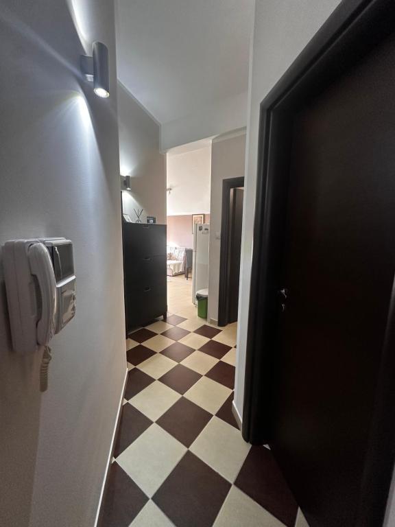 a hallway with a checkered floor in a bathroom at Angella apartment Tivat in Tivat