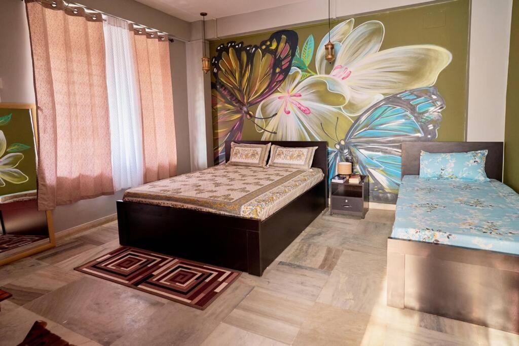 een slaapkamer met een bed en een schilderij aan de muur bij Malini Homes Unit - 2 in Guwahati