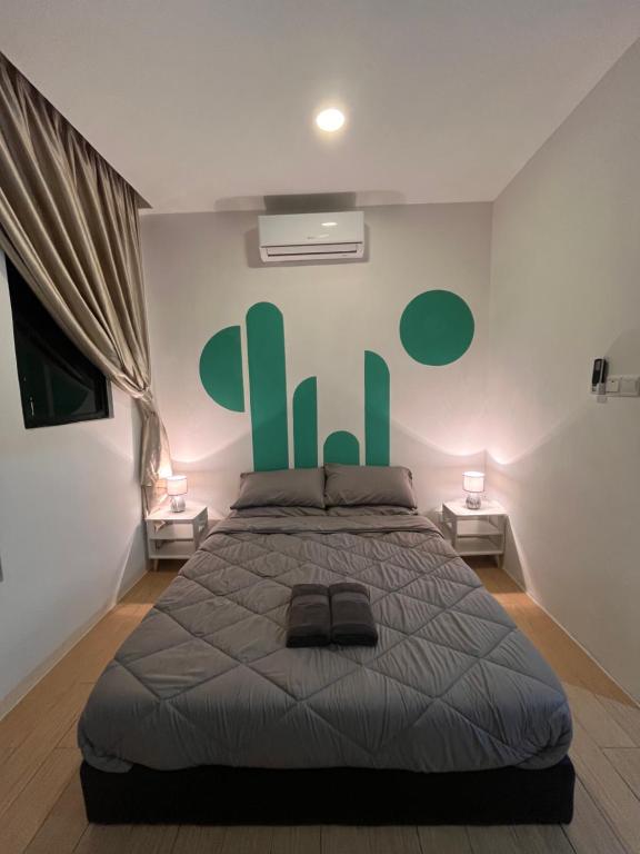 a bedroom with a bed with a green sign on the wall at FJ Haven in Penampang