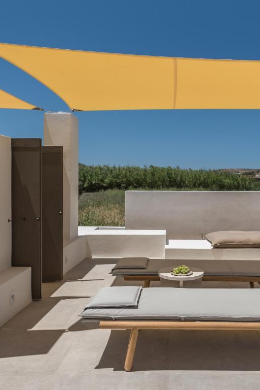 a living room with a bed and a table at Parilio, a Member of Design Hotels in Naousa