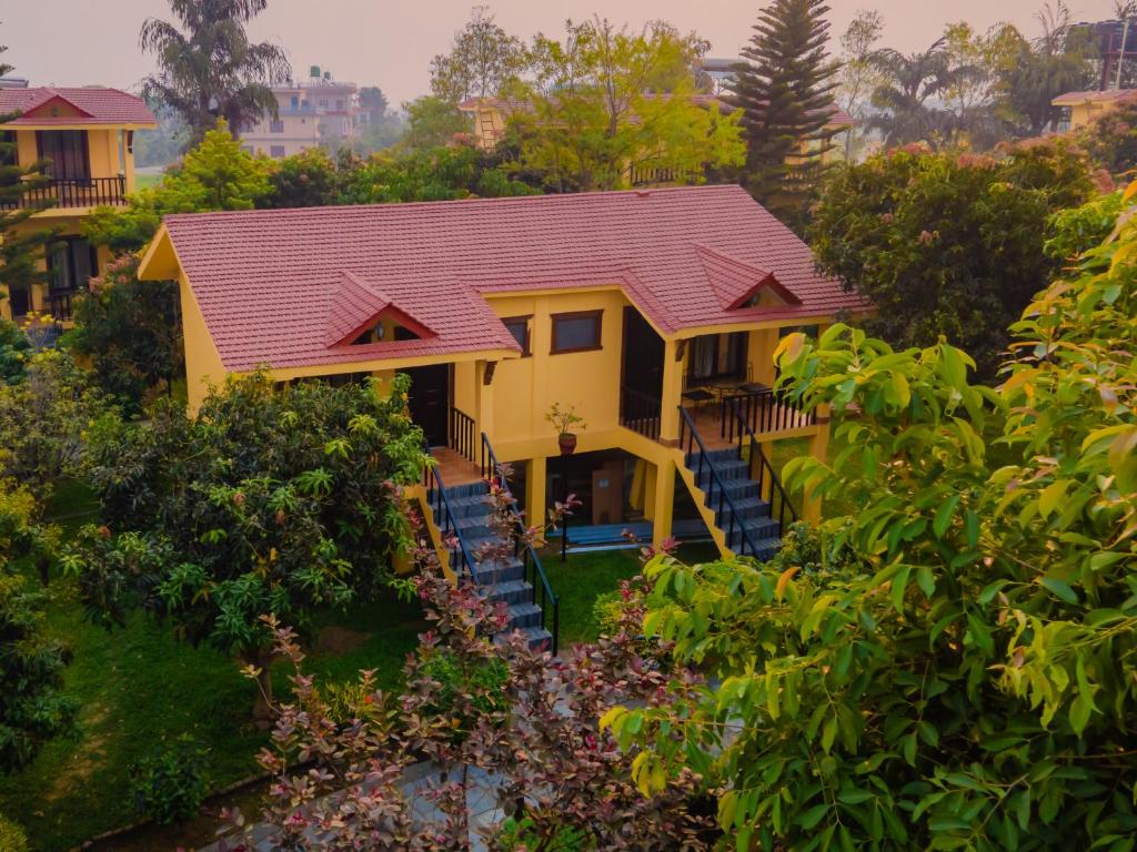 a house with a red roof at Hotel Seven Star in Sauraha