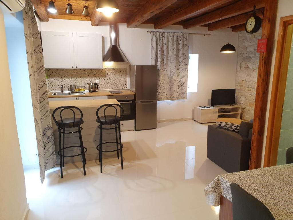 eine Küche mit zwei Barhockern und einer Theke in der Unterkunft Apartman Martina in Sveti Filip i Jakov