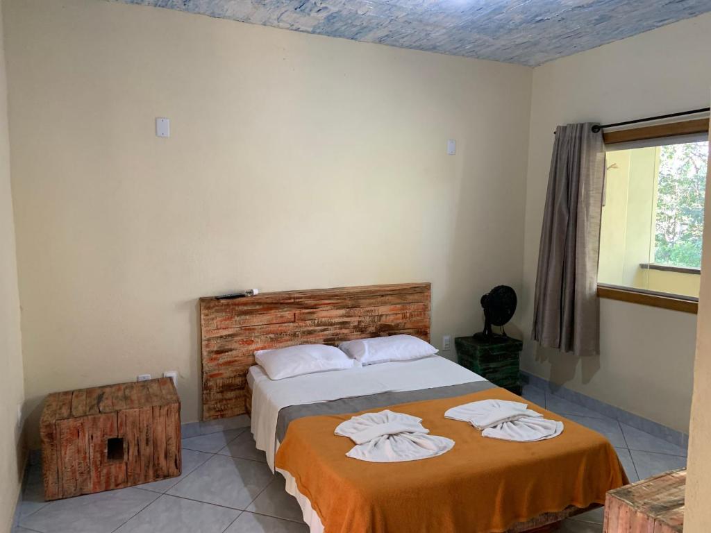 Een bed of bedden in een kamer bij Pousada Casinha Velha