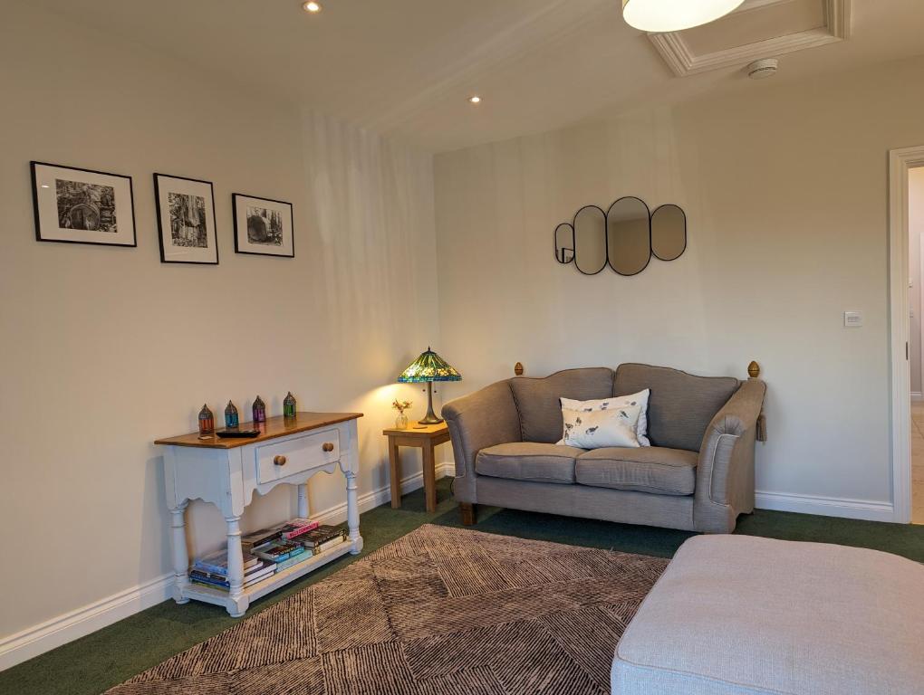 a living room with a couch and a table at Little Chilsbury in Potterne