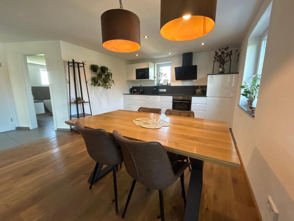 a dining room with a wooden table and chairs at Apartment Ihm in Memmingen