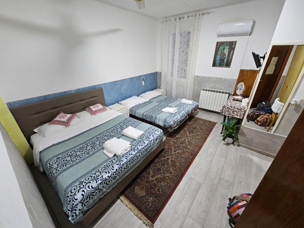 Postel nebo postele na pokoji v ubytování Hotel Giovannina