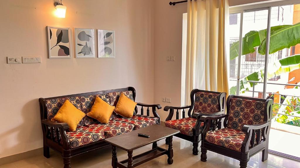 a living room with a couch and two chairs at Pebbles 2BHK Home By Goaround Homes in Siolim