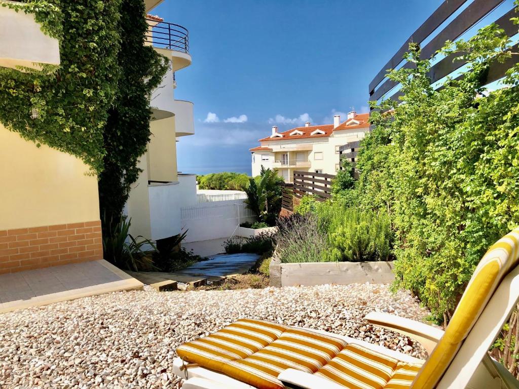 a bench sitting on the side of a building at Sleep & Surf Ericeira - Portugal in Ericeira