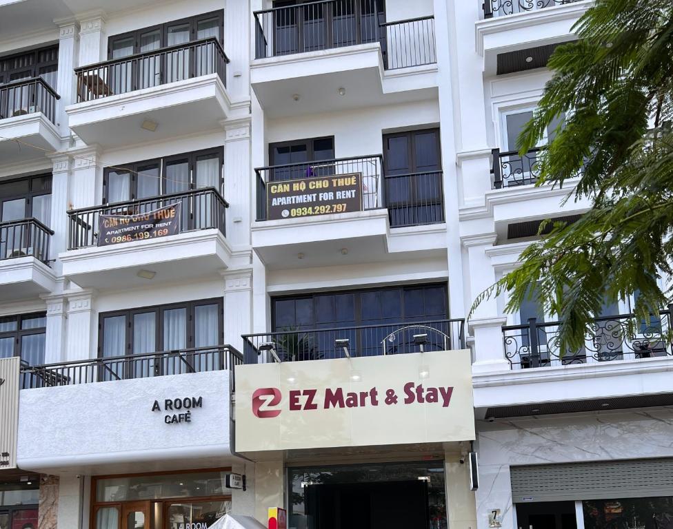 a white building with a le marriott stay sign at Ez mart and stay in Hai Phong