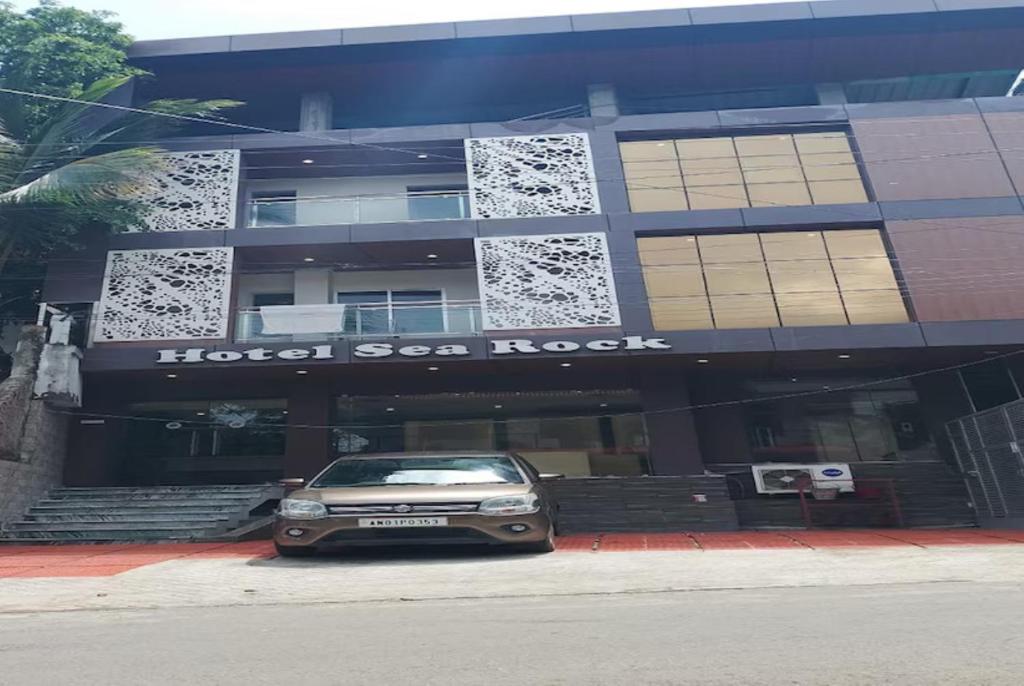 a car parked in front of a hotel sooke at Hotel Sea Rock Porte Blair in Port Blair