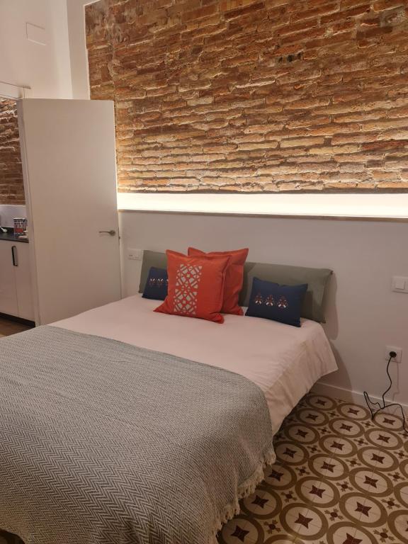 a bedroom with a bed with red pillows on it at Poble Sec Charming Apartment in Barcelona