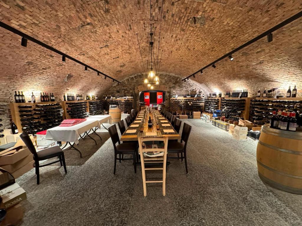 a large wine cellar with a long table and chairs at Hotel Ristorante Grotto Serta in Lamone