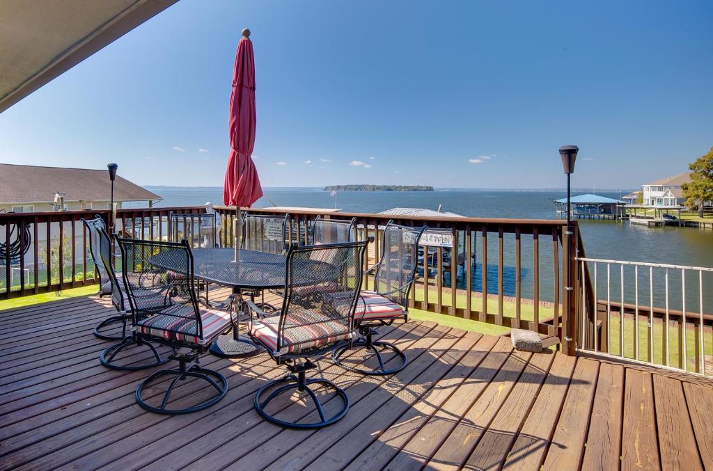 a patio with a table and chairs and an umbrella at Spacious Livingston Home with Private Boat Dock in Livingston