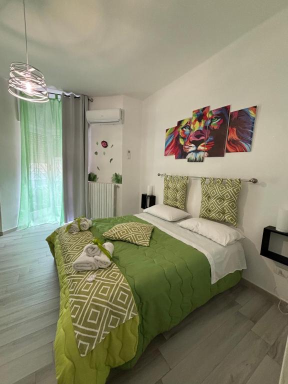 a bedroom with a bed with a green blanket at Rosaria's Home in Brindisi