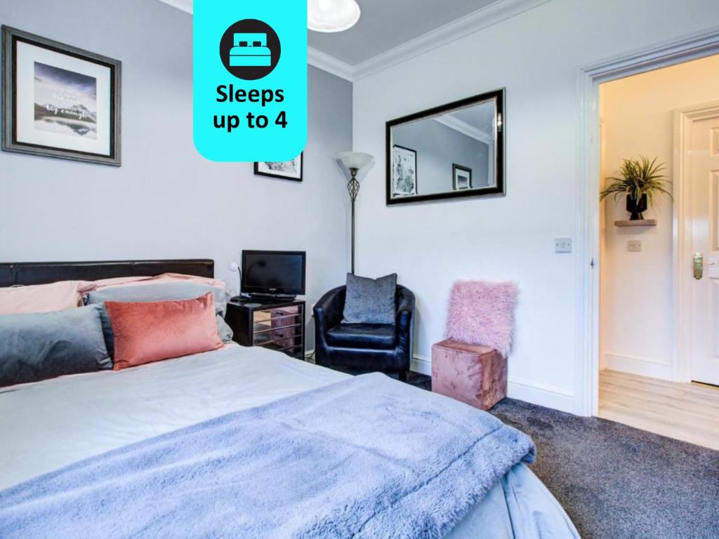 a bedroom with a bed and a chair at Modern 2-Bedroom - 2 Bathroom Apartment in Waltham Abbey-Gated Car Park-Fast Internet in Waltham Abbey