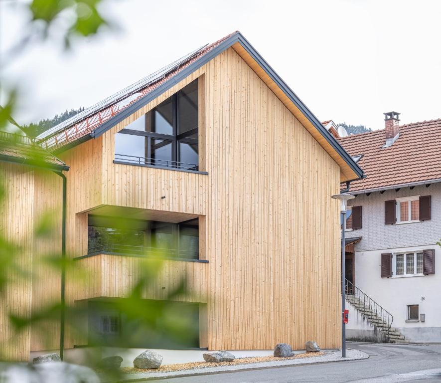 a house with a wooden facade at Alpen Krone Kehlegg in Dornbirn