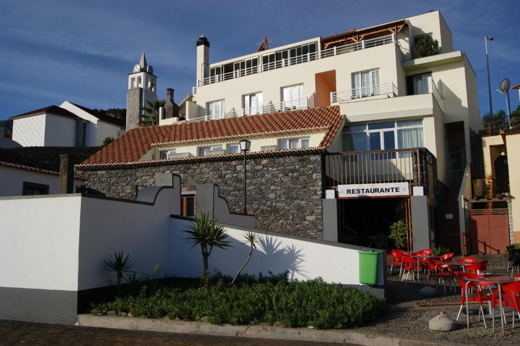 a large building with a large window at Hotel Costa Linda in Porto da Cruz