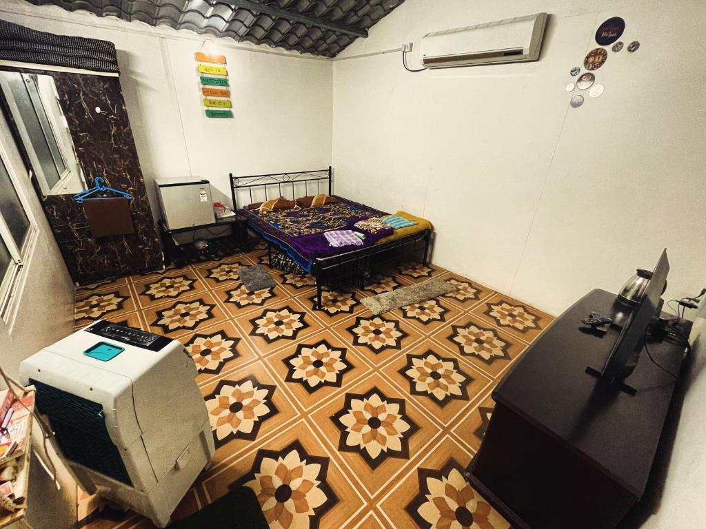 a room with a room with a bed and a table at Bougain Villa- Sinhgad fort -Bedroom- Garden- Kitchen- AC- Wi-Fi-Parking-Khadakwasala Pune in Kharakvasla