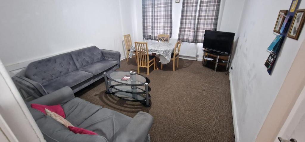 a living room with a couch and a table at SIMPLE 2BED FLAT IN EDINBURGH. in Edinburgh