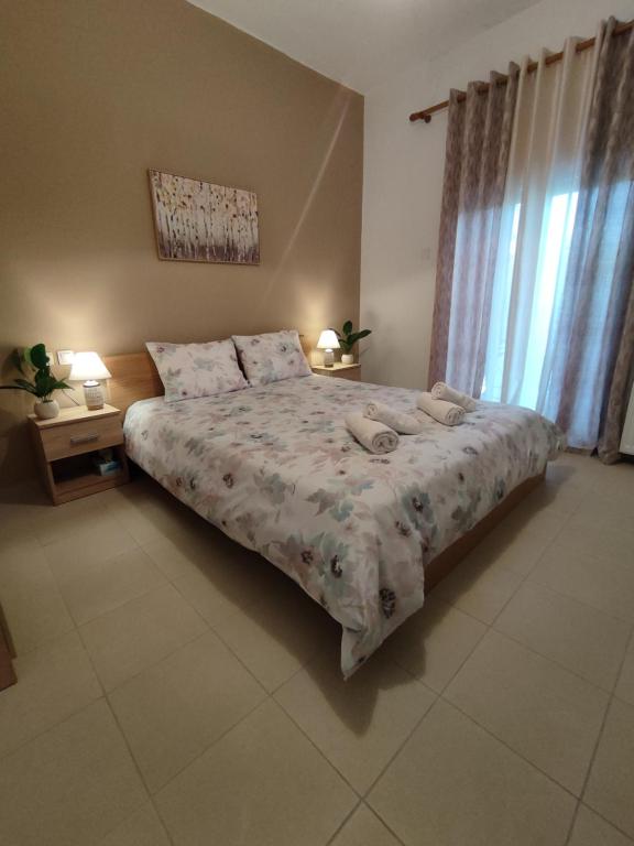 Un dormitorio con una cama grande y una ventana en Kritharia Guesthouse Volos, en Kritharia