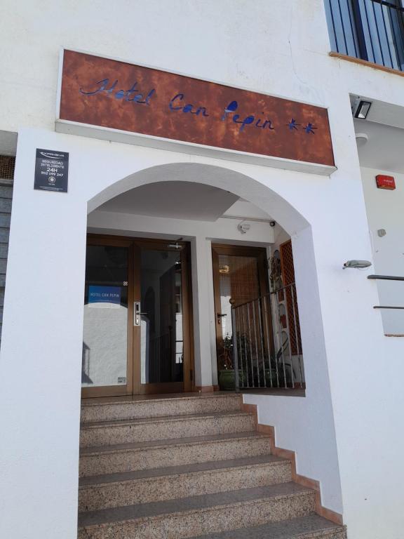 una entrada a un edificio con una escalera en Hotel Can Pepin, en Cadaqués