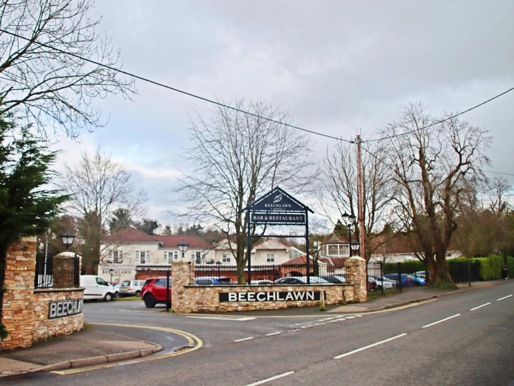 a building with a sign in the middle of a street at Beechlawn Hotel in Belfast