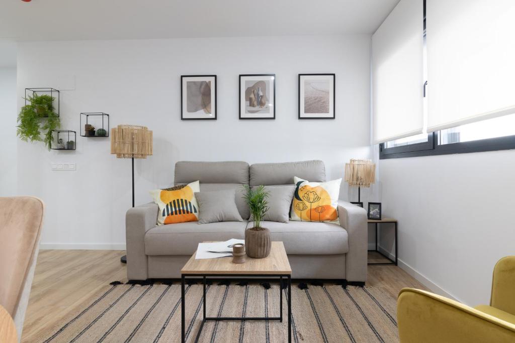 a living room with a couch and a table at Dorm4You Arena Plaza in Valencia