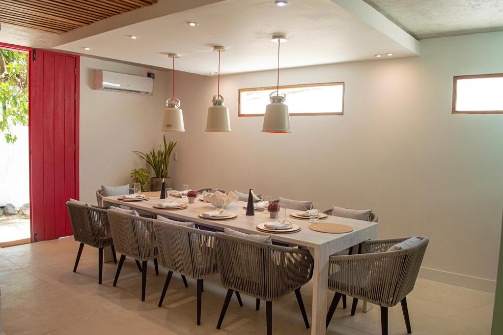 a dining room with a long table and chairs at Sabbia By LD Hoteles in El Roque