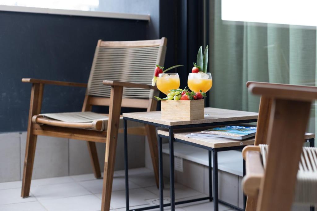 a table with a chair and two drinks on it at Dorm4You Arena Terraza 04 in Valencia