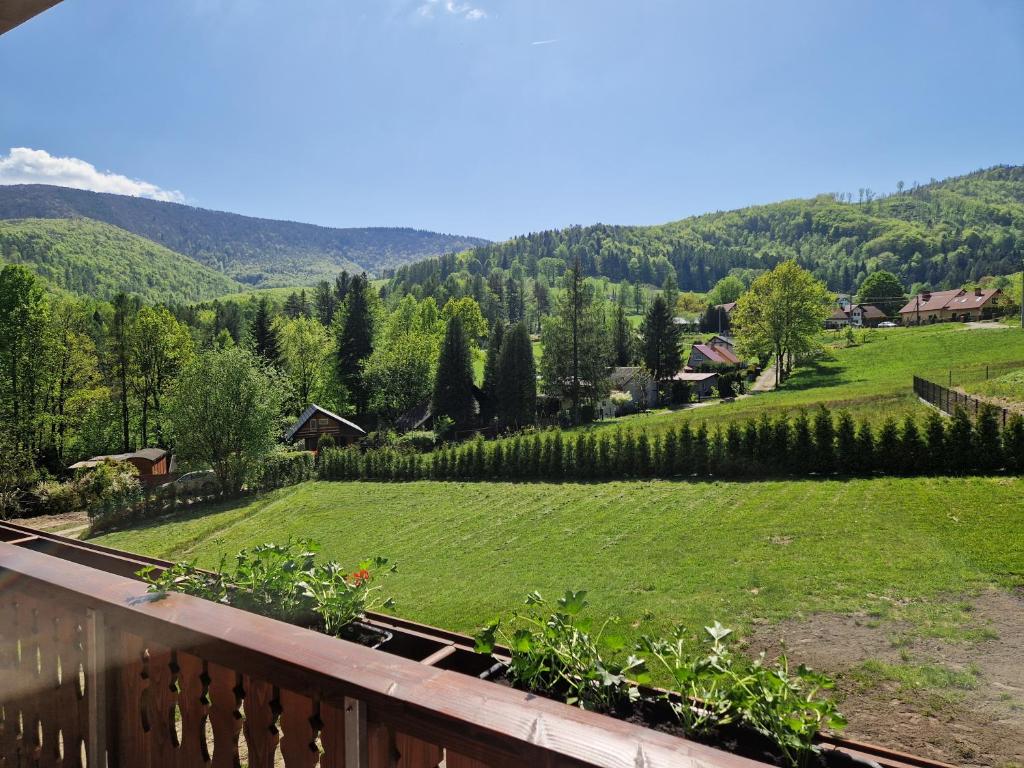 a balcony with a view of a green field at Beskidylla in Ustroń