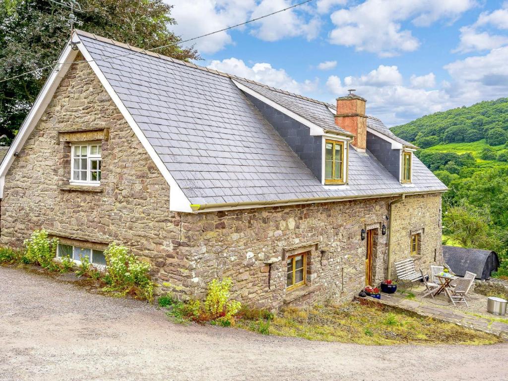 a stone house with a gambrel roof on top at 3 Bed in Crickhowell 48309 