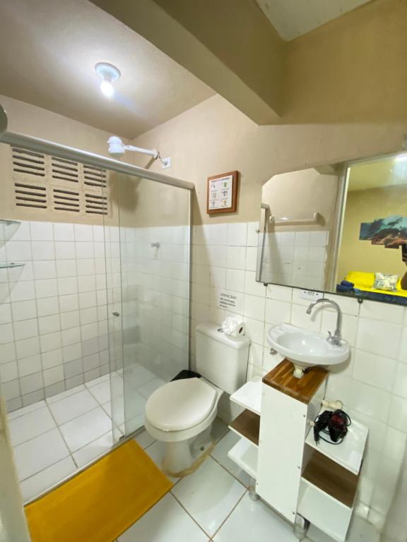 a bathroom with a toilet and a shower and a sink at Casa Silveira NORONHA in Fernando de Noronha
