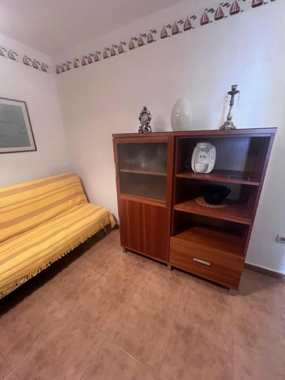 a bedroom with a bed and a wooden cabinet at Apartamento Zahara in Zahara de los Atunes