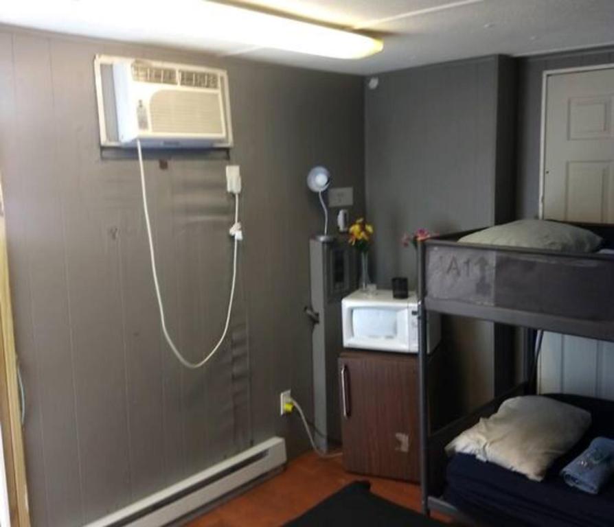 a room with a room with a air conditioner on the wall at Co-ed Dorm with Fantastic Patio! in Ewing