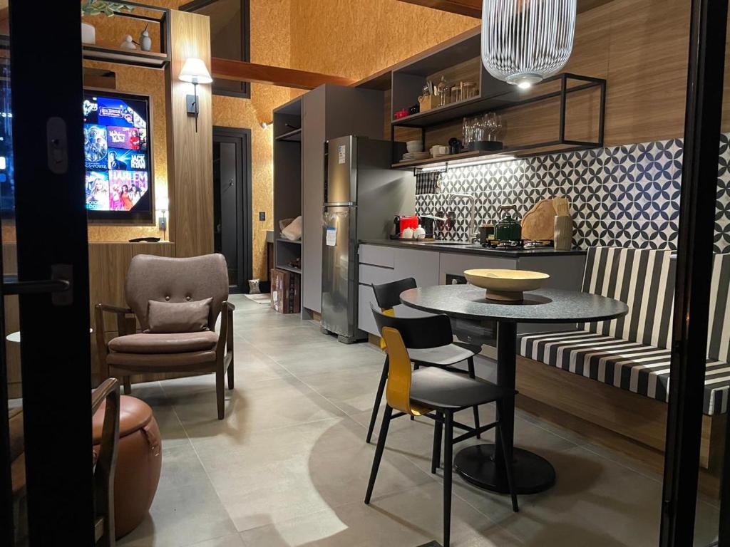 Soular Lodge e Fazenda في ساو فرانسيسكو دي باولا: مطبخ مع طاولة وكراسي في الغرفة