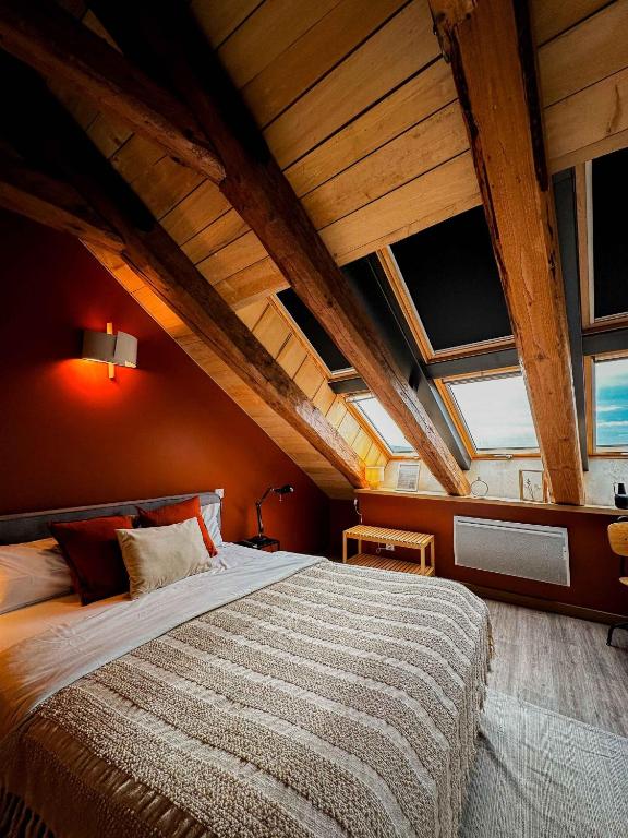 a bedroom with a large bed in an attic at La Ferme du Bien-etre in Saint-Julien-Chapteuil