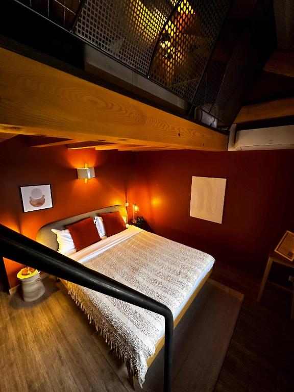 a bedroom with a bunk bed with an orange wall at La Ferme du Bien-etre in Saint-Julien-Chapteuil