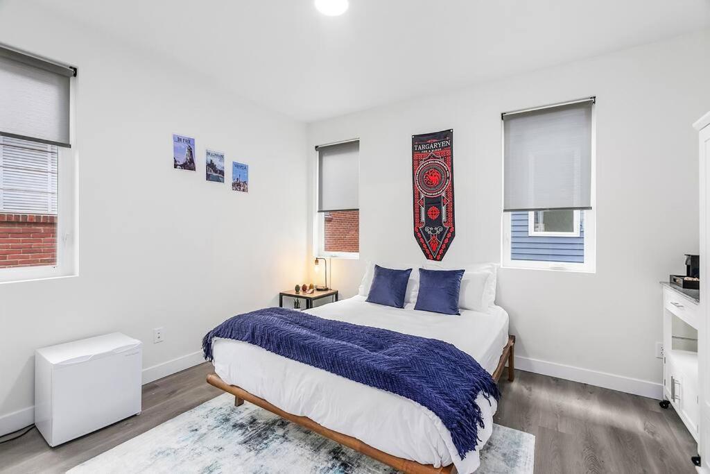 a white bedroom with a bed and windows at Highgarden The Seat of House Tyrell Sweet Suite in Seattle