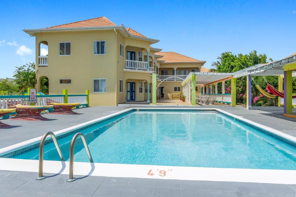 a swimming pool in front of a house at Taino Cove in Treasure Beach